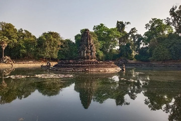 île du temple de Neak Pean entourée d'eau se reflétant dans un bassin