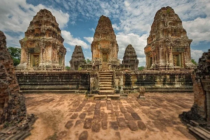 ancient stone temple ruins with multiple towers in Cambodia
